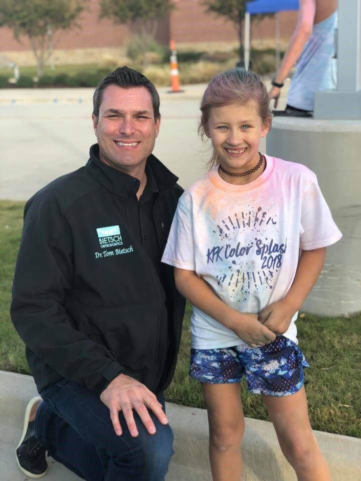 Dr. Bietsch with child from the fun run